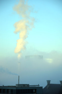 A picture of the ERZ power plant chimney and of the Prime Tower, both in Zurich (Switzerland)