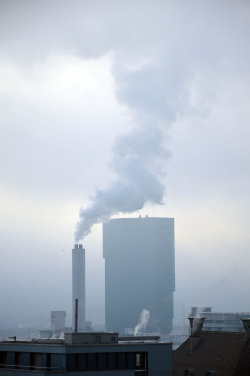 A picture of the ERZ power plant chimney and of the Prime Tower, both in Zurich (Switzerland)