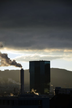 A picture of the ERZ power plant chimney and of the Prime Tower, both in Zurich (Switzerland)