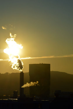 A picture of the ERZ power plant chimney and of the Prime Tower, both in Zurich (Switzerland)