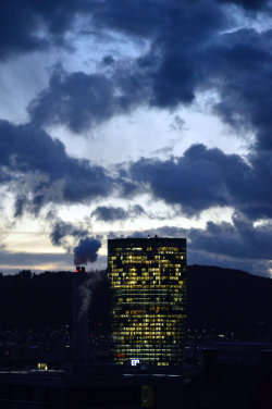 A picture of the ERZ power plant chimney and of the Prime Tower, both in Zurich (Switzerland)