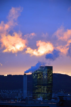 A picture of the ERZ power plant chimney and of the Prime Tower, both in Zurich (Switzerland)