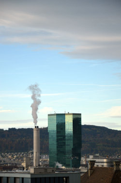 A picture of the ERZ power plant chimney and of the Prime Tower, both in Zurich (Switzerland)