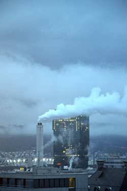 A picture of the ERZ power plant chimney and of the Prime Tower, both in Zurich (Switzerland)