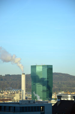 A picture of the ERZ power plant chimney and of the Prime Tower, both in Zurich (Switzerland)