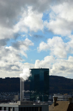A picture of the ERZ power plant chimney and of the Prime Tower, both in Zurich (Switzerland)