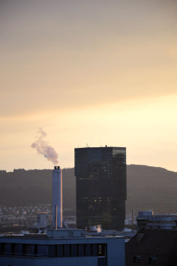 A picture of the ERZ power plant chimney and of the Prime Tower, both in Zurich (Switzerland)