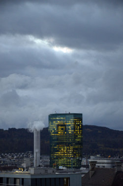 A picture of the ERZ power plant chimney and of the Prime Tower, both in Zurich (Switzerland)