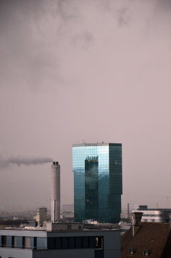 A picture of the ERZ power plant chimney and of the Prime Tower, both in Zurich (Switzerland)