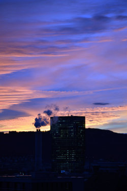 A picture of the ERZ power plant chimney and of the Prime Tower, both in Zurich (Switzerland)