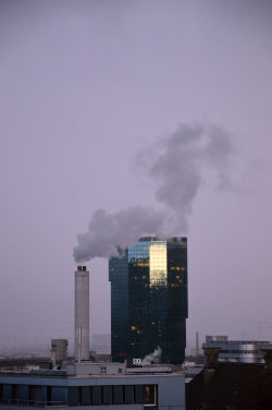 A picture of the ERZ power plant chimney and of the Prime Tower, both in Zurich (Switzerland)