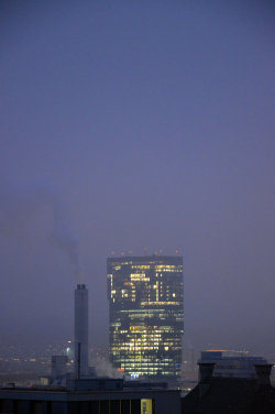 A picture of the ERZ power plant chimney and of the Prime Tower, both in Zurich (Switzerland)