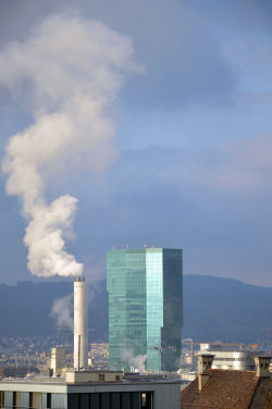 A picture of the ERZ power plant chimney and of the Prime Tower, both in Zurich (Switzerland)