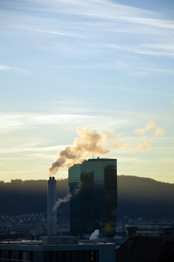 A picture of the ERZ power plant chimney and of the Prime Tower, both in Zurich (Switzerland)