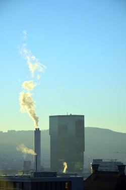 A picture of the ERZ power plant chimney and of the Prime Tower, both in Zurich (Switzerland)