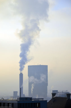 A picture of the ERZ power plant chimney and of the Prime Tower, both in Zurich (Switzerland)